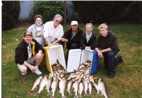 Group of people showing off their fish catch